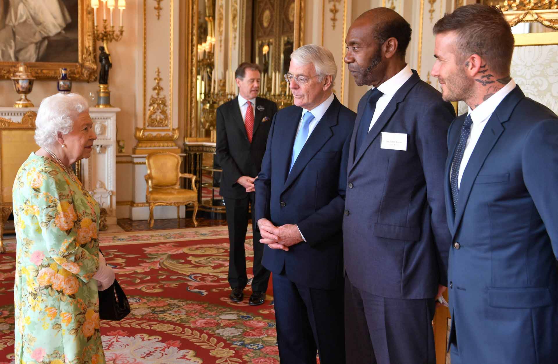 Queen Elizabeth II meets (left to right) Sir John Major, Sir Lenny Henry and David Beckham attend the Queen’s Young Leaders Awards ceremony at BuckinghamPalace in London, Tuesday, June 26, 2018.  *** Local Caption *** .